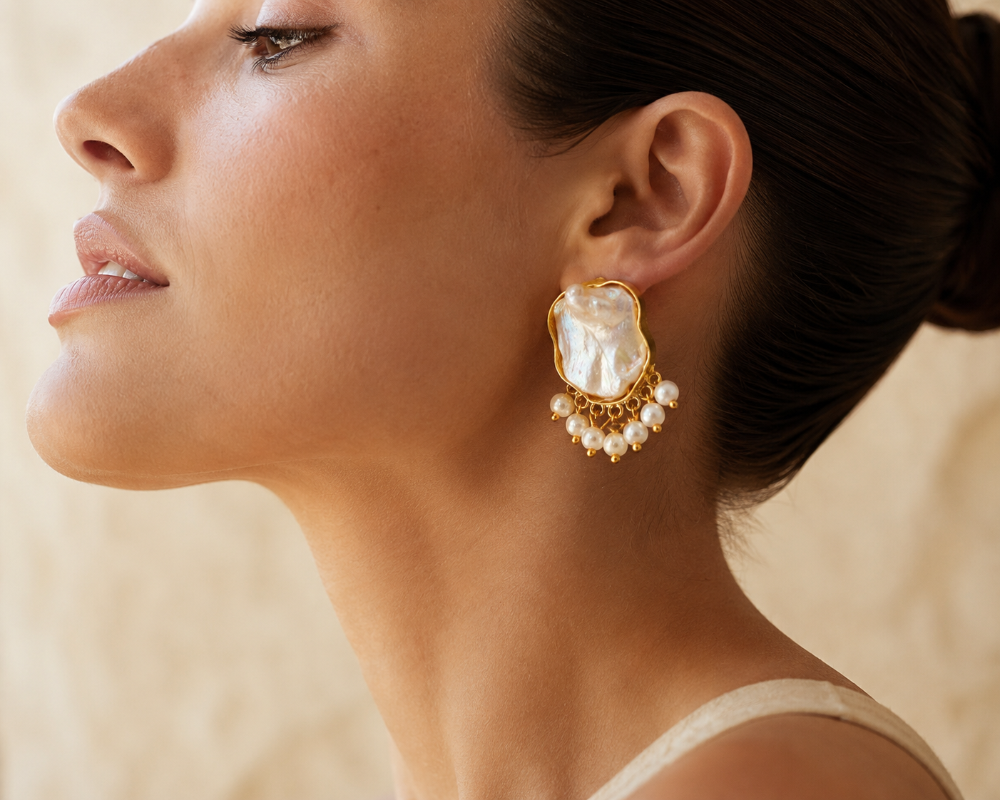 Macro detail of mother-of-pearl fringe earring on model's ear