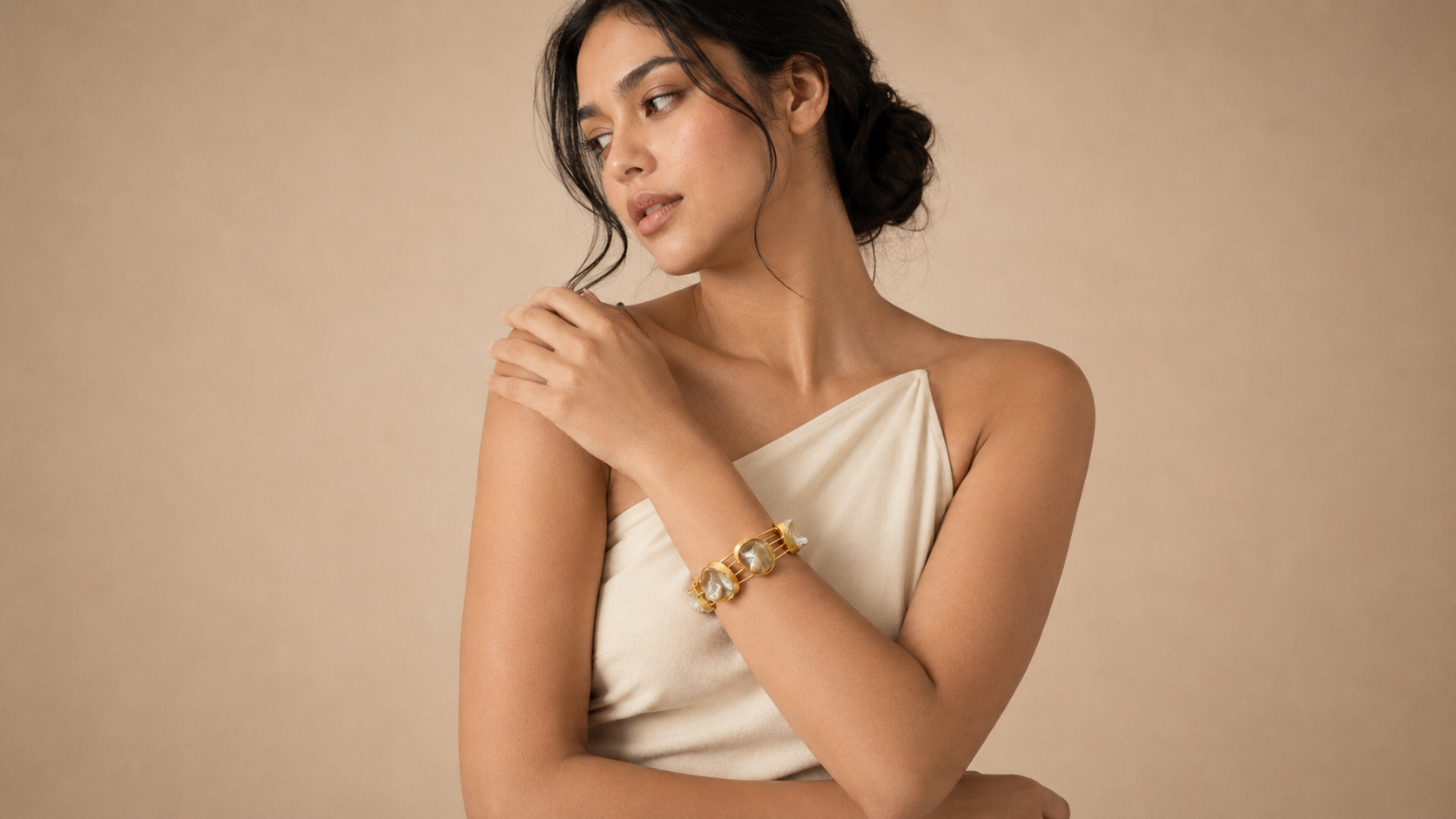 Model wearing baroque pearl cuff bracelet, cream outfit